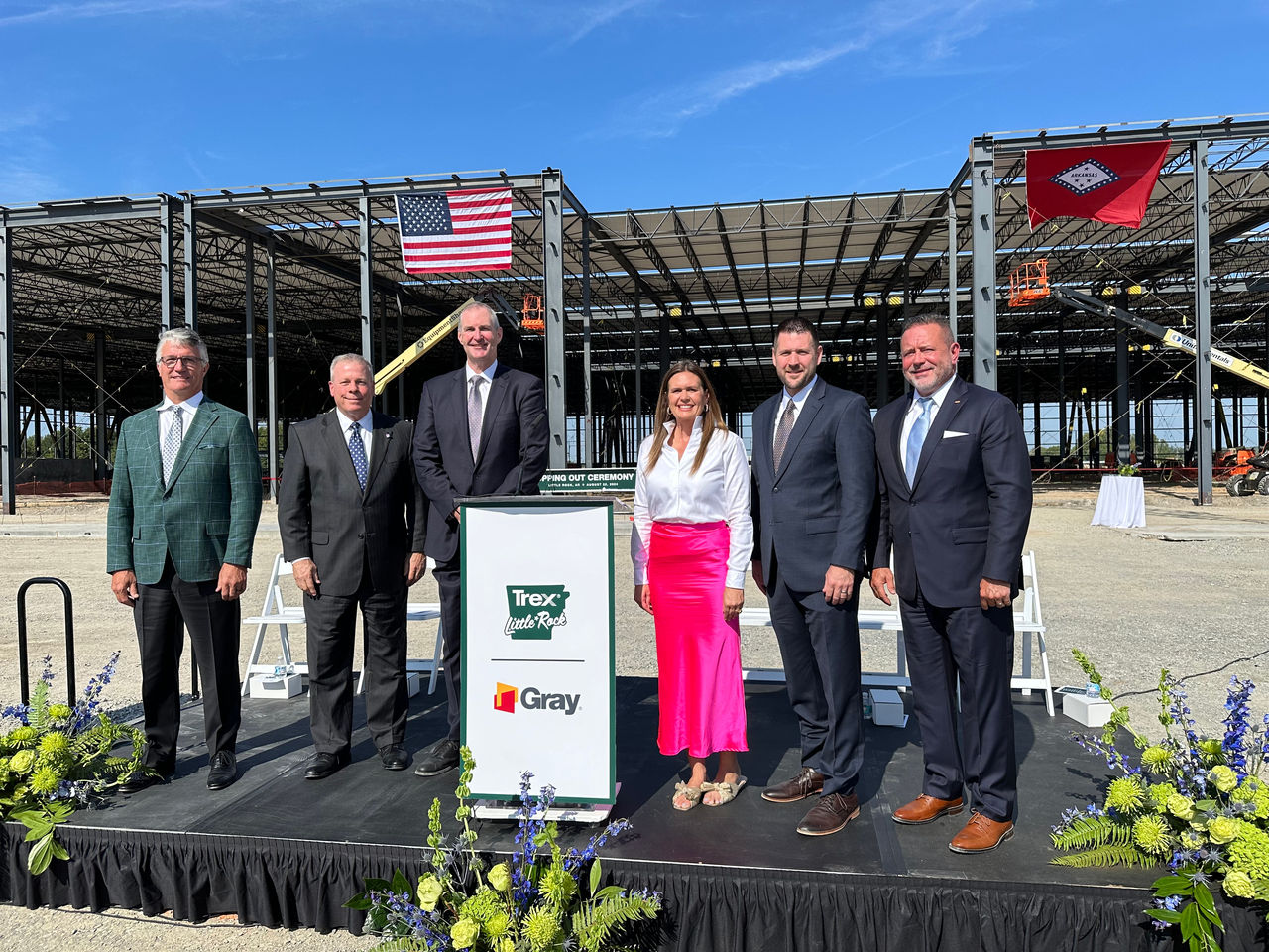 CEO Brian Fairbanks and other key people in Arkansas government take a photo in front of what will be the new Little Rock Trex plant.