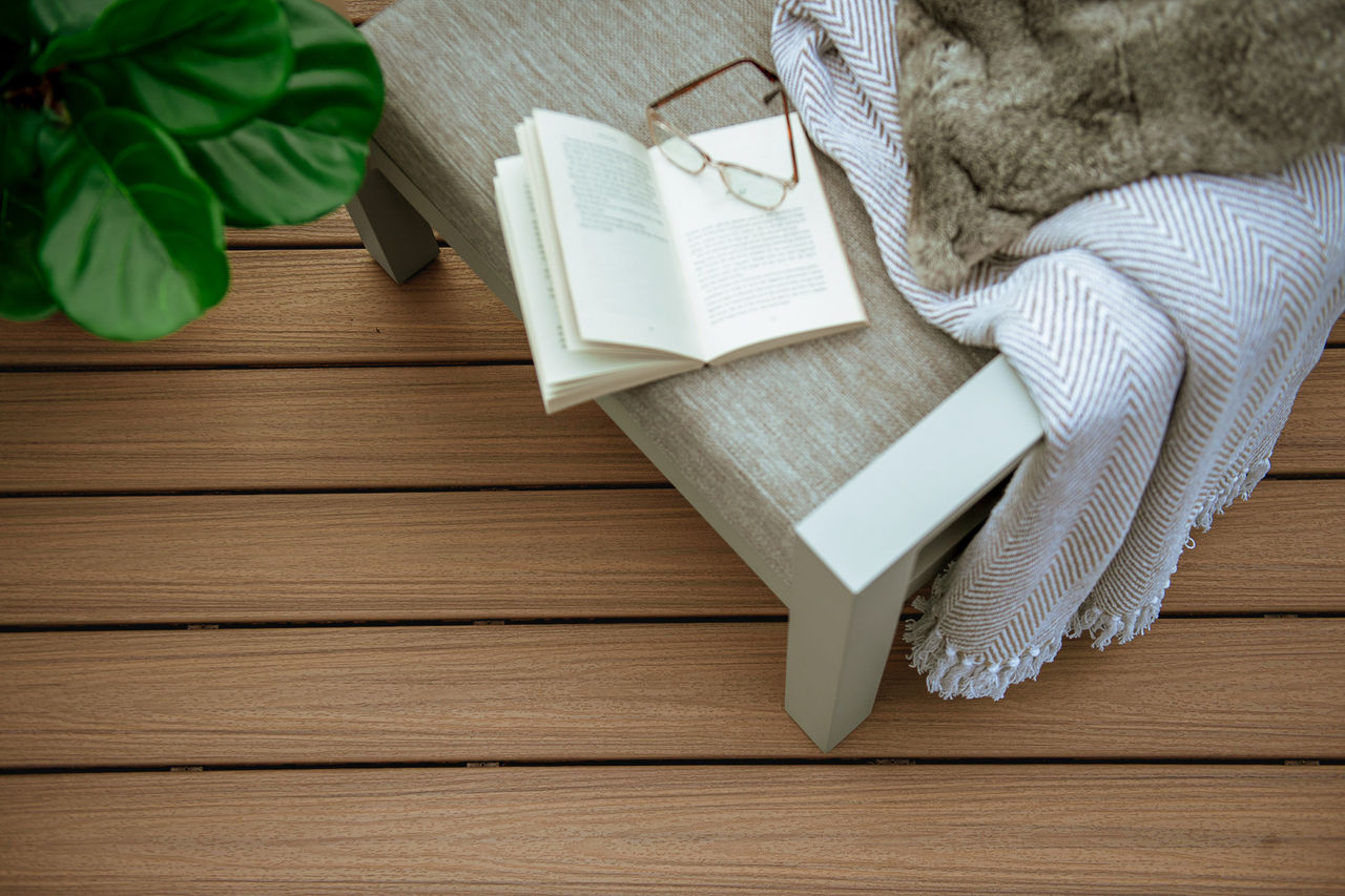 golden hour decking with book and glasses